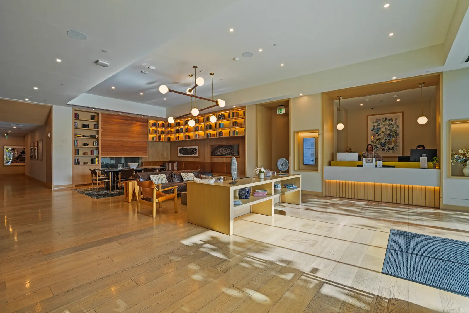 Lobby with built-in bookshelves, lounge seating and the staffed front desk