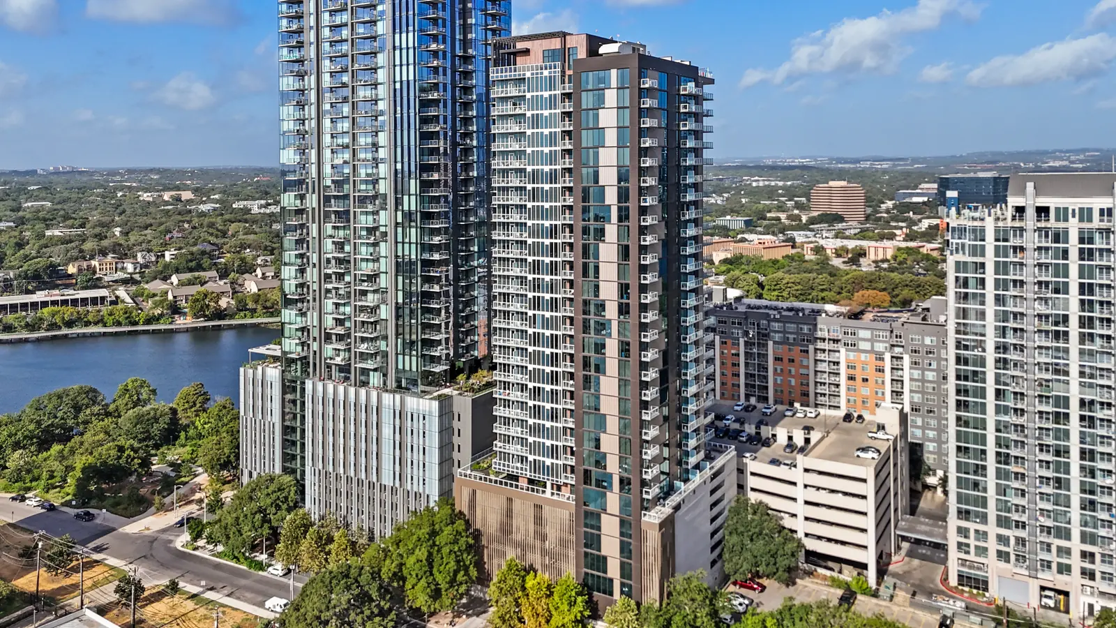 Aerial view of the Natiivo building and neighboring towers beside Lady Bird Lake