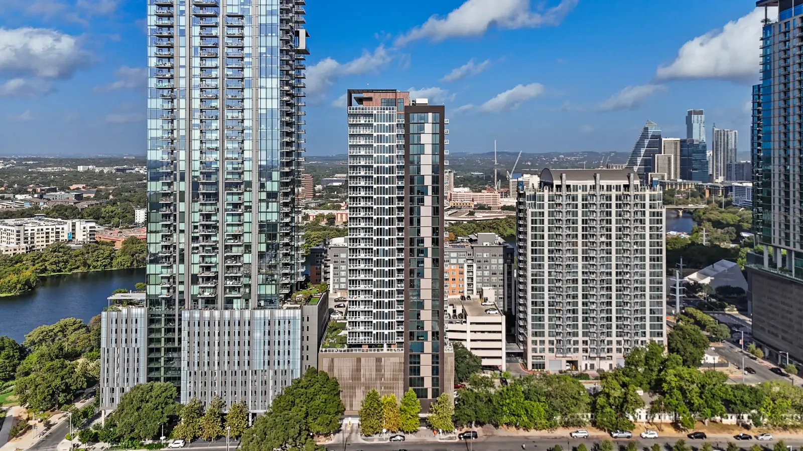 Aerial view of high-rise towers in the Rainey Street area with Lady Bird Lake to the left